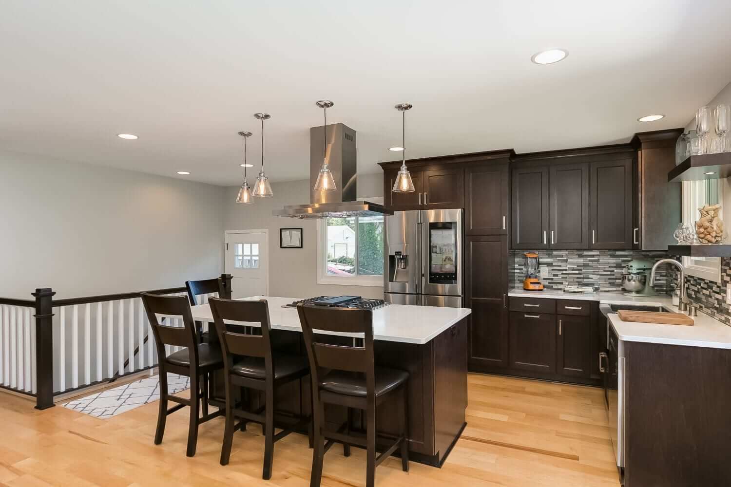 Kitchen remodeling with granite countertops and pendant lights.